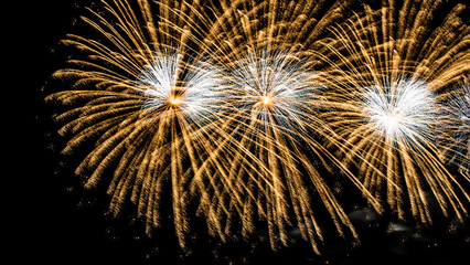 Obraz premium Montreal, Canada - June 25 2022: Fire works show with quarter moon in background at La Ronde in Montreal