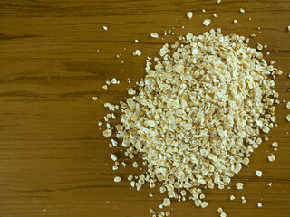 Rolled oats on wooden table
