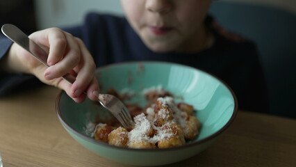 Little Boy Eating Gnocchi, Close-Up of Pensive Five-Year-Old Enjoying Meal