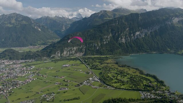 Flying over Switzerland with paraglider - majestic drone shot