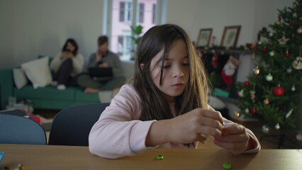 Little Girl Focused on Toy Assembly, 8-Year-Old Engrossed in Play by herself