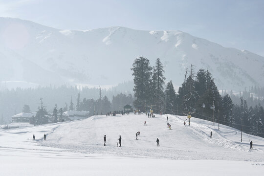 Gulmarg, Jammu and Kashmir /  India - December 19, 2019 : Tourists are enjoying the skiing activity in Gulmarg, in Jammu and Kashmir.