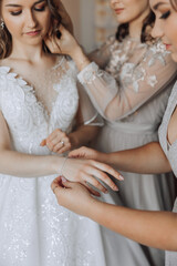 Wedding bride and bridesmaid help with jewellery bracelet for elegant and classic fashion glamour....