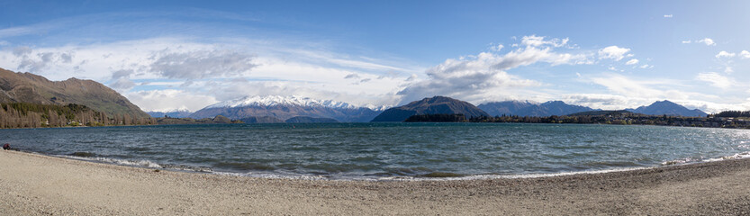 panoramic view of wakana lake in new zealand with snowy mountain in the background