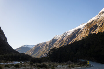 road to mild ford sound with snowy mountain in the background