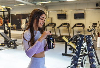 Fitness, health and woman drinking water on her break at gym for training, exercise and cardio...