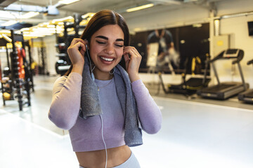 Woman, gym and earphones for music, thinking and listening for inspiration to workout for wellness. Young girl, audio streaming subscription and hearing for exercise, training or fitness with sound.