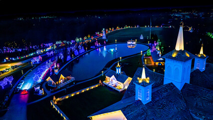 Aerial View At Night Of A Serene Complex With Buildings And Pathways Illuminated By Festive Lights,...