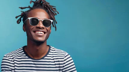 Foto op Canvas Portrait photograph of a young man smiling, dressed in stylish sunglasses and a striped t-shirt © yganko