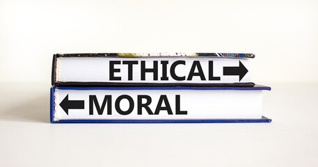 Ethical or moral symbol. Concept word Ethical or Moral on beautiful books. Beautiful white table white background. Business and ethical or moral concept. Copy space.