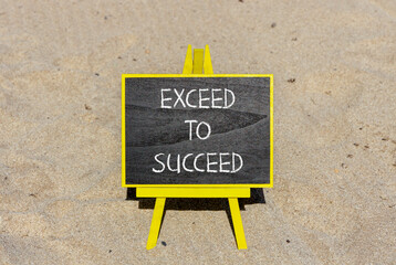 Exceed to succeed symbol. Concept words Exceed to succeed on beautiful black chalk blackboard. Beautiful sand beach background. Business and exceed to succeed concept. Copy space.