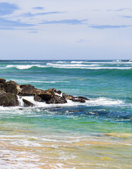 Scenic tropical beach and sky with clouds. Vertical photo.