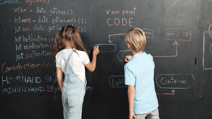 Caucasian girl and smart boy writing blackboard with engineering prompt or coding, programing...