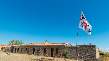 Sardinia flag with an abandoned building  on the background - 744155671