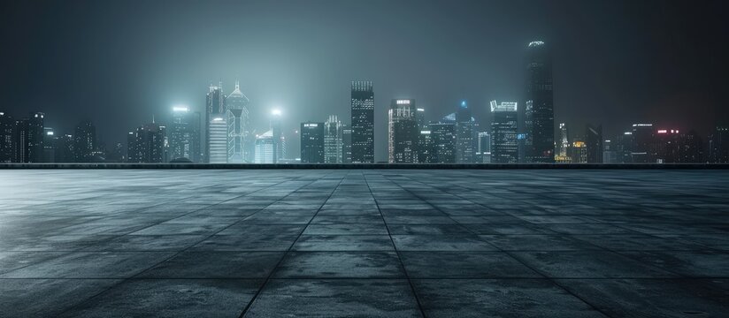 A photograph showcasing a spacious concrete room with an expansive city skyline at night.