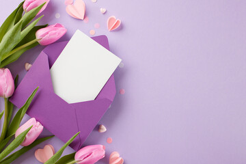 Spring festivities: warm greetings for the seasons celebrations. Top view shot of pink tulips, purple envelope, white blank card, paper hearts on lavender background with space for messages