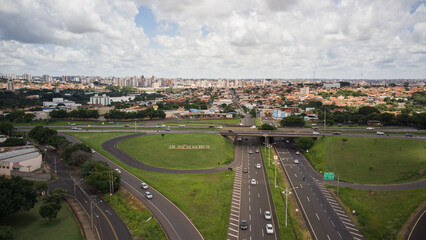 Aerial drone view of the entrance to the city of São José do Rio Preto, in Brazil, with the roads in the foreground and the city in the background, with the sign in evidence