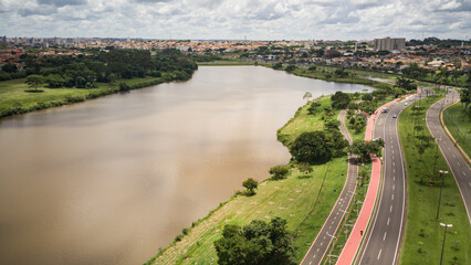 Aerial drone landscape of the São José do Rio Preto municipal dam on a sunny day, with the rivers and city on the city postcard on a cloudy day.