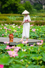 Woman at lotus flower lake - 744184606