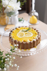 Lemon cupcake with lemon filling on a light table among flowers