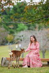 Woman feeding deer in Nara
