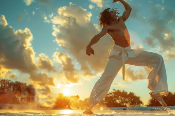 Zelfklevend Fotobehang An individual practicing capoeira at sunset, their movements a blend of dance and martial arts against the backdrop of fading light. © maxwellmonty