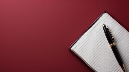 Elegant notebook and pen on a red background
