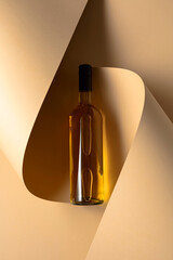 Bottle of white wine on a beige background.