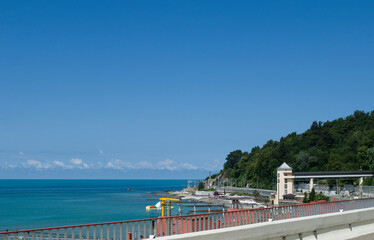 view of the calm blue sea and green forested mountains