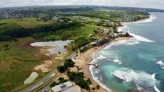 Aerial slow-motion of Penon Amador Beach on a sunny day in Camuy, Puerto Rico