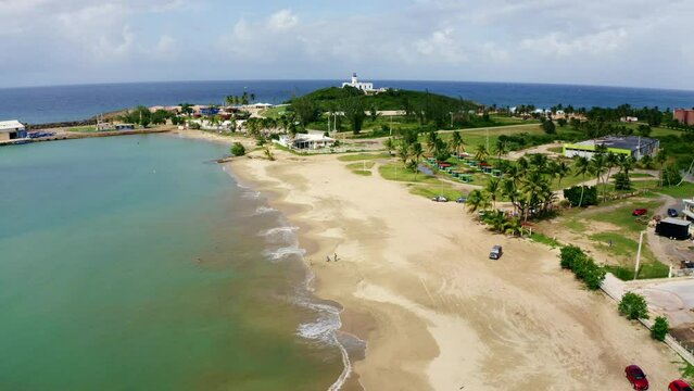 Drone view of cloudy sky over Penon Amador Beach with greenery and soft sand in Camuy, Puerto Rico
