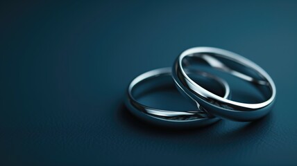 Close-up of two wedding bands on a dark background