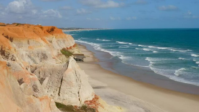 Aerial view of Morro Branco beach, from the cliff to the sea, Ceara, Brazil