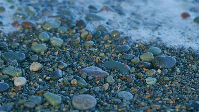 Calm Beach Waves On Shore. Sea Waves And Surfs Are Splashing Pebble And Small Pebble On A Seashore.