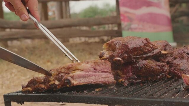 Chef placing the juicy, tasty and extremely soft roasted meat on the grill