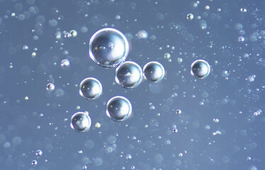 Bubbles in water on a blue background. Close-up.