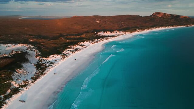 drone shot over Lucky BAy at sunset in Cape Legrand National Park with 4WD on the beach, Western Australia
