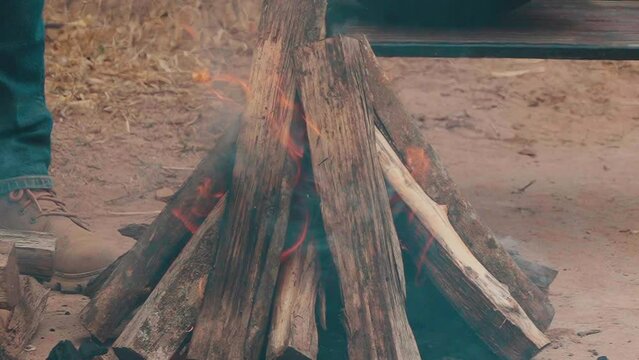 Man observing charcoal and firewood for the grill. Paraguayan asado