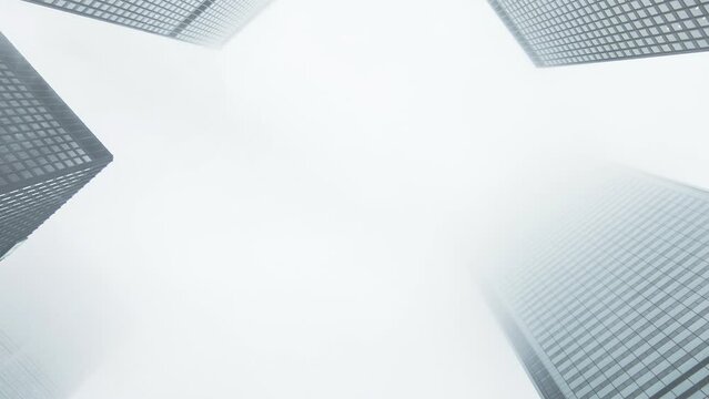Zooming up buildings on a cloudy day with fog.