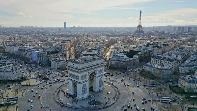 Triumphal arch or Arc de Triomphe with Tour Eiffel in background, Paris cityscape, France. Aerial drone panoramic view