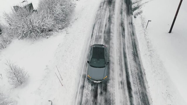 Drone footage of car driving in the winter forest road. Landvetter, Sweden