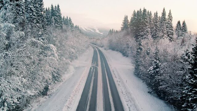 Drone footage of a snowy road in northern Sweden
