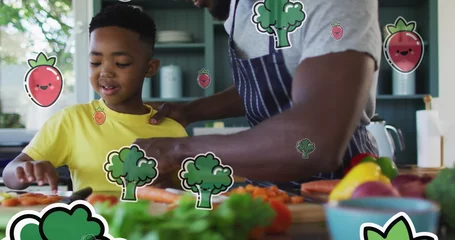  Image of vegetables floating over happy african american father and son preparing meal © vectorfusionart
