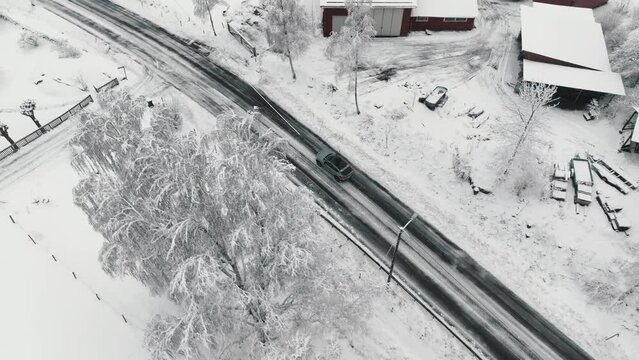 Drone footage of car driving in the winter forest road. Landvetter, Sweden
