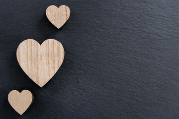 Obraz premium Wood hearts shape on the black nature background.