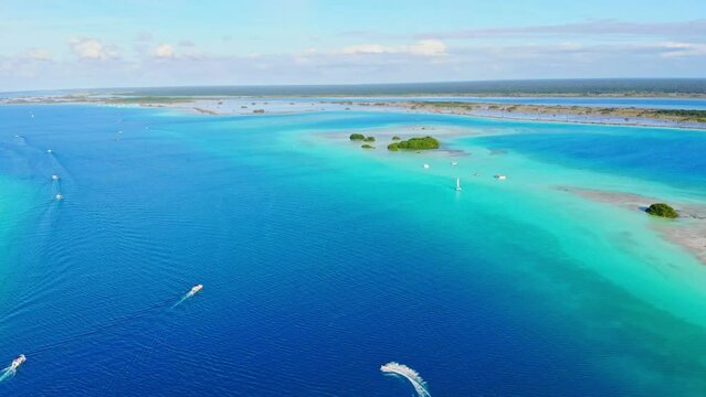 Paradise Laguna De Los 7 Colores with Boats Sailing the Turquoise Waters, an Aerial Drone Panning Shot.