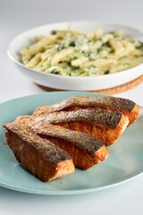 Salmon steak with pasta with blue cheese and broccoli
