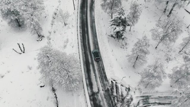 Drone footage of car driving in the winter forest road. Landvetter, Sweden