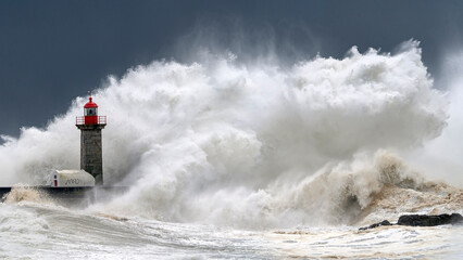 Lighthouse and large oceanic wave in a storm, Porto, Portugal