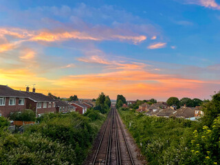 Breathtaking colors of morning sky over railway on the outskirts of Canterbury